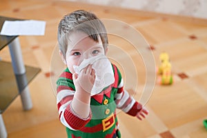Child suffering from running nose or sneezing. Allergic little boy