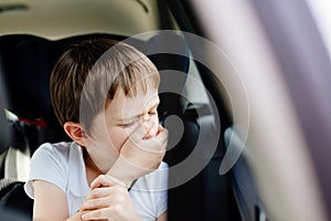 Child suffers from motion sickness in car photo