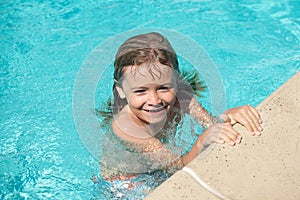 Child in summer swimming pool. Boy Practice Swimming.