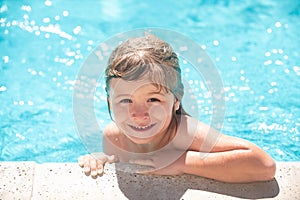 Child in summer swimming pool. Little boy playing in outdoor swimming pool in water on summer vacation. Child learning