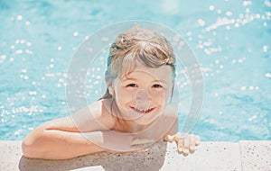 Child in summer swimming pool. Little boy playing in outdoor swimming pool in water on summer vacation. Child learning