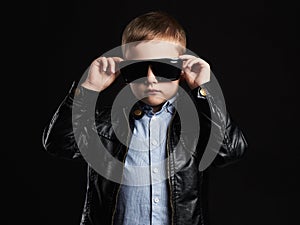 Child in sunglasses.fashionable handsome little boy in leather