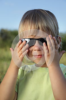 Child in sunglasses summer outdoors