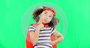 Child, superhero and thinking on green screen to stop crime and fight with fantasy or cosplay costume. Girl power, hero