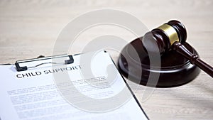 Child support document table, gavel lying on sound block, family law, court