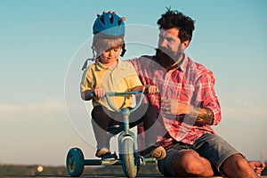 Child support and protection. Happy father and son with bike outdoors. Family, Father`s Day, parenting, active lifestyle