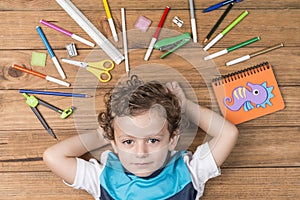 Child surrounded by school supplies