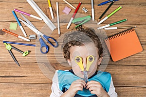 Child surrounded by school supplies