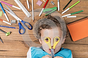 Child surrounded by school supplies