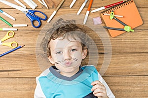 Child surrounded by school supplies