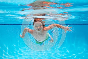 Child swim and dive underwater in the swimming pool. Beach sea and water fun.