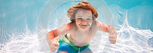 Child swim and dive underwater in the swimming pool. Kids holidays and summer vacation concept.