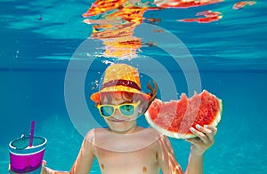 Child swim and dive underwater in the swimming pool. Summer watermelon.