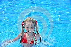 Child swim in swimming pool.