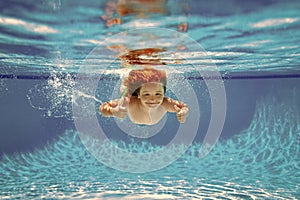 Child swim under water in sea. Kid swimming in pool underwater. Happy boy swims in sea underwater, active kid swimming