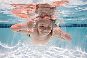 Child swim under water in sea. Kid swimming in pool underwater. Happy boy swims in sea underwater. Children in water