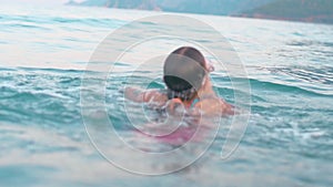 Child swimming and diving into sea water during summer holidays