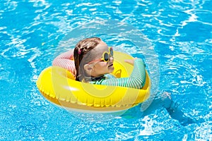 Child in swimming pool. Kids swim. Water play.