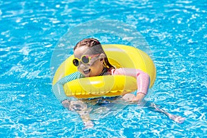 Child in swimming pool. Kids swim. Water play.