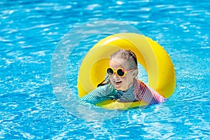 Child in swimming pool. Kids swim. Water play