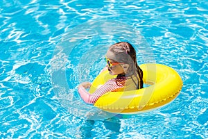 Child in swimming pool. Kids swim. Water play