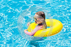 Child in swimming pool. Kids swim. Water play