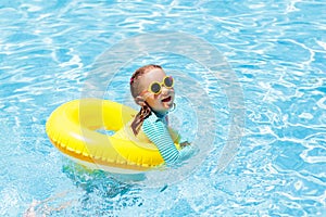 Child in swimming pool. Kids swim. Water play