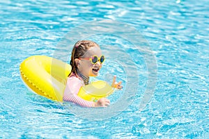 Child in swimming pool. Kids swim. Water play