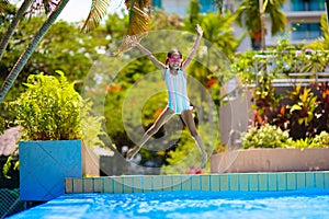 Child in swimming pool on ring toy. Kids swim