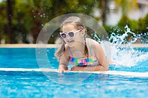 Child in swimming pool. Summer vacation with kids.