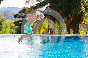 Child in swimming pool. Summer vacation with kids