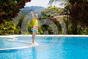 Child in swimming pool. Summer vacation with kids