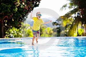 Child in swimming pool. Summer vacation with kids.