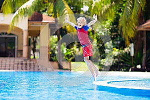 Child in swimming pool. Summer vacation with kids