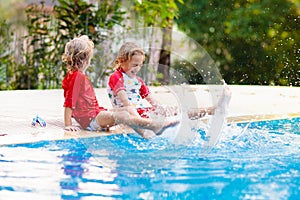 Child in swimming pool. Summer vacation with kids