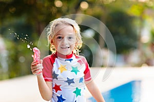 Child in swimming pool. Summer vacation with kids