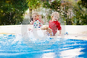 Child in swimming pool. Summer vacation with kids