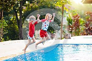 Child in swimming pool. Summer vacation with kids