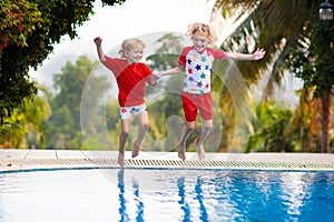 Child in swimming pool. Summer vacation with kids