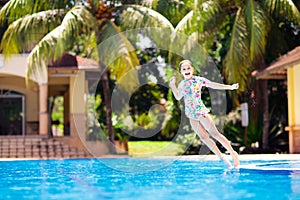 Child in swimming pool. Summer vacation with kids