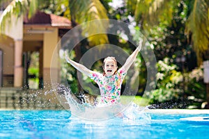 Child in swimming pool. Summer vacation with kids