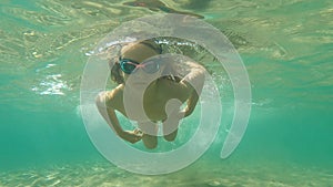 Child swimming underwater in a sea
