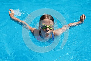 Child swims butterfly style