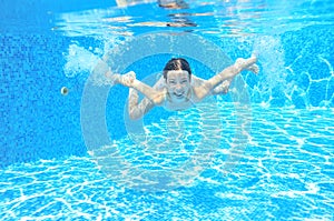 Child swims in pool underwater