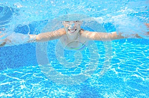 Child swims in pool underwater