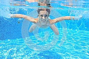 Child swims in pool underwater