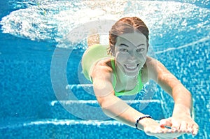 Child swims underwater in swimming pool, happy active teenager girl dives and has fun under water, kid fitness and sport