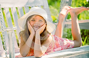 Child swing on backyard. Kid playing oudoor. Happy cute little girl swinging and having fun healthy summer vacation photo