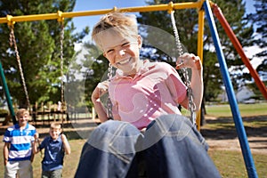 Child, swing and energy on playground in portrait, smile and outdoor adventure in childhood for recreation at park