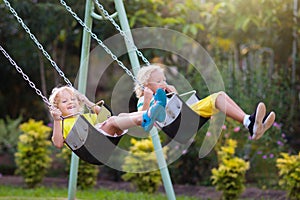 Child swinging on playground. Kids swing